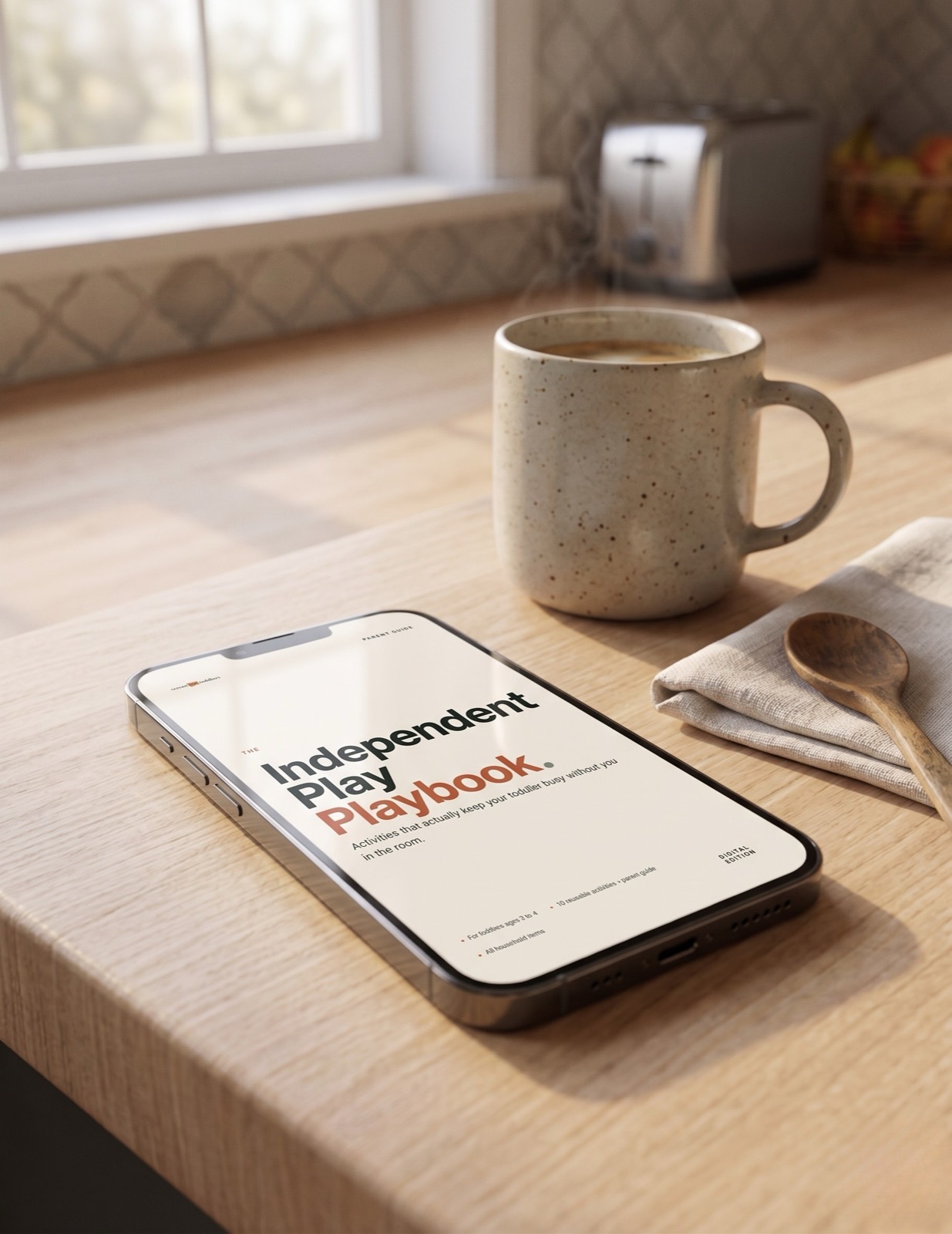 The Independent Play Playbook PDF open on a phone, held in one hand